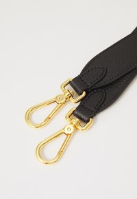 Black leather strap with a textured finish, featuring gold-tone metal clips and hardware on each end for attachment.