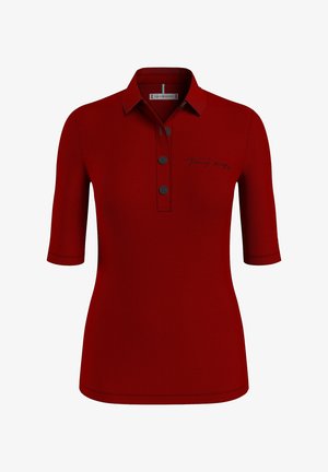 Czerwona koszulka polo z krótkim rękawem, trzema guzikami i wyszywanym logo "Tommy Hilfiger" na lewej piersi.