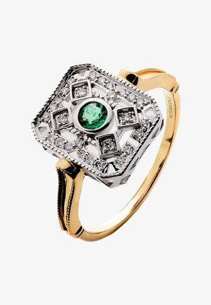 Anillo de oro con montaje rectangular de plata, con un esmeralda verde redondo central rodeado de diamantes en patrones geométricos.