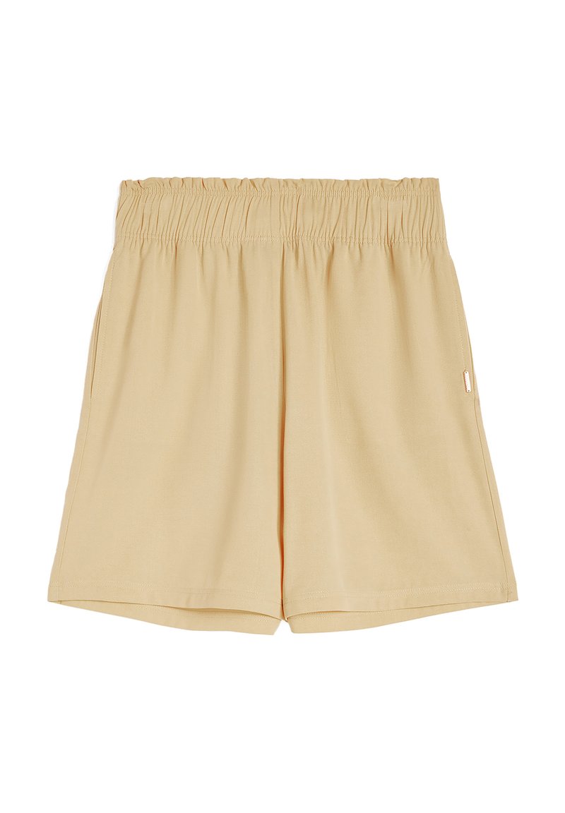 Pantaloni corti beige in cotone con cintura elastica, tasche laterali e vestibilità rilassata. Tessuto liscio e design semplice. Senza motivi visibili.