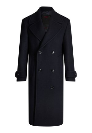 Manteau long noir en laine à double boutonnage avec larges revers, poignets boutonnés et poches latérales, conçu pour les temps froids.