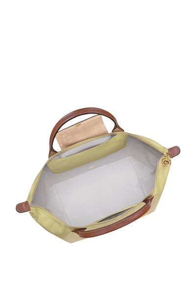 Large yellow tote bag with brown textured handles. Interior features a soft lining and a flat pocket, designed for versatile use.