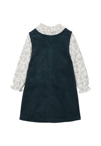 Dunkelblaues Corduroykleid mit einer weißen, langärmeligen Bluse darunter. Es hat einen Rüschenausschnitt und eine Knopfleiste auf der Rückseite.