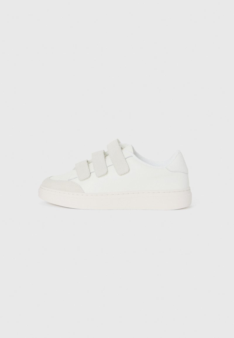 White sneaker with a smooth leather upper, three Velcro straps on the vamp, rounded toe, and a chunky light-colored rubber sole.