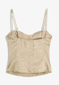 Beige satin cami top with a spotted pattern, featuring thin adjustable straps and a fitted silhouette. Smooth texture and a subtle sheen.