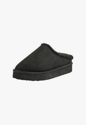 Pantofole nere senza lacci con parte superiore morbida e testurizzata, rivestite in pelliccia, e una suola spessa e imbottita. Design arrotondato con una finitura liscia.