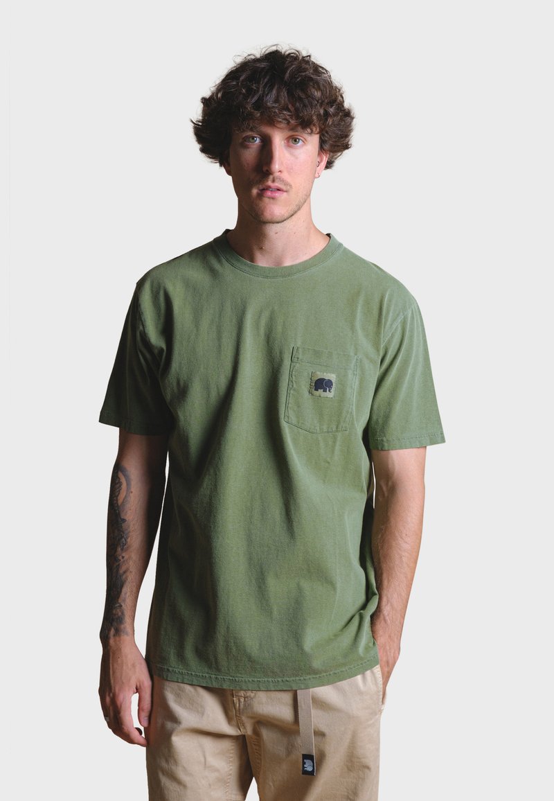 Olive green cotton t-shirt with crew neck, short sleeves, and a chest pocket featuring a black elephant design. Relaxed fit.