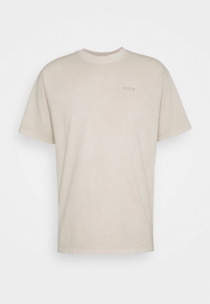 T-shirt en coton beige à manches courtes, décolleté rond et logo Levi's brodé subtilement à l'avant. Texture douce, design décontracté.