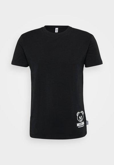 T-shirt in cotone nero con maniche corte, caratterizzato da una grafica di un orso bianco e il testo "Moschino" sul lato sinistro in basso. Collo rotondo.