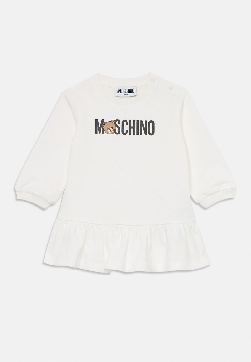 Λευκό φόρεμα μωρού με μακριά μανίκια και ριγέ τελειώματα, λογότυπο MOSCHINO και πρόσωπο αρκούδας στο στήθος, με κουμπιά snap στον ώμο.