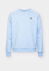Ljusblå sweatshirt med rund hals, ribbade ärmslut och nederdel. Har en liten mörkblå Adidas-logotyp på vänster bröst. Tillverkad av mjukt material.