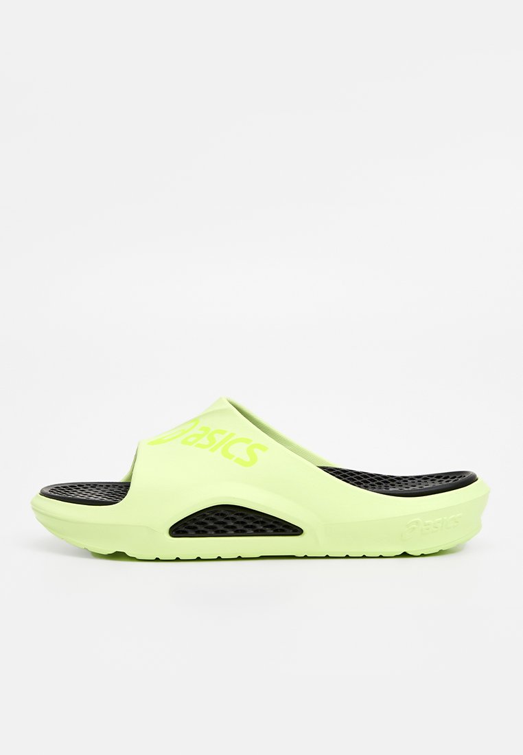 Light green slide sandals with a textured black insole. Features a prominent logo, open-toe design, and circular perforations for ventilation.