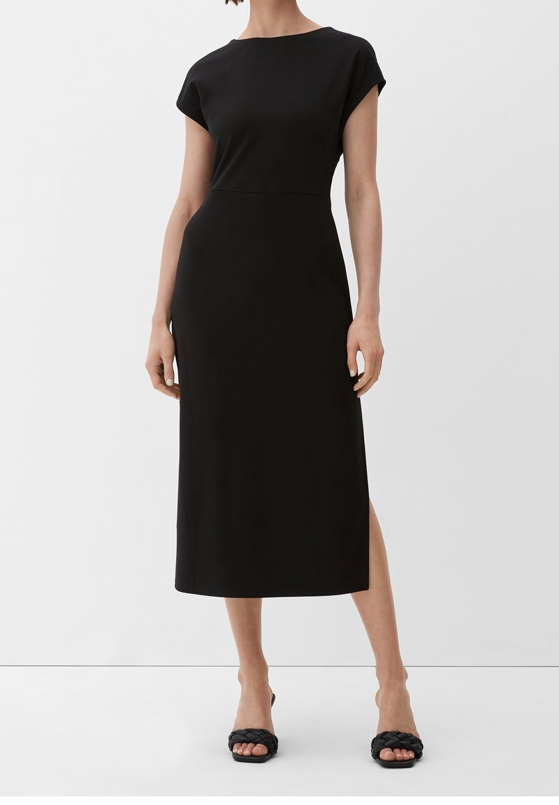 Black midi dress with cap sleeves, straight cut, and side slit. Made from smooth fabric, featuring a simple and sleek design.