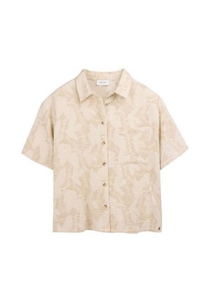 Chemise beige à manches courtes avec un motif discret de feuilles et une poche poitrine, fabriquée en tissu texturé.
