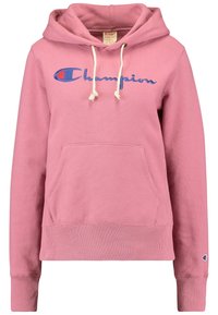 Un sweat à capuche rose fabriqué à partir d'un matériau doux, doté d'une poche avant, d'une capuche avec cordon de serrage et d'un logo "Champion" brodé en bleu.