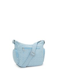 Light blue crossbody bag with geometric pattern, zippered pockets, adjustable strap, and smooth textured fabric. Compact and functional design.