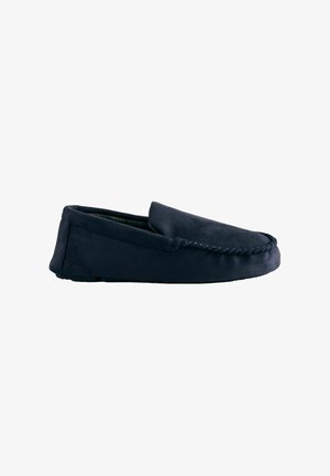 Navy blue moccasin slipper made of soft suede with a stitched upper and no prominent hardware. Simple, low-profile design.