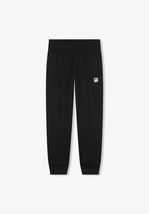 Pantalones de chándal negros con una cinturilla acanalada, piernas estrechas, costuras laterales y un pequeño logo de DKNY en rojo y blanco en el muslo izquierdo.