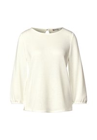 Maglietta bianca a maniche lunghe con scollatura rotonda, tessuto texturizzato e maniche arricciate. Include un dettaglio a forma di occhiello sul retro.
