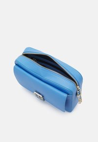 Modrá kožená kabelka s texturovaným povrchem, zipovým uzávěrem a stříbrným kovovým akcentem na přední straně. Kompaktní, obdélníkový tvar.