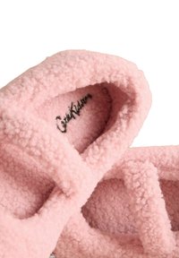 Pantofole in pile rosa con design incrociato, texture morbida e forma arrotondata. L'interno presenta un logo. Adatte per l'uso interno.