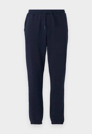 Marineblå sweatpants lavet af blød stof, med elastisk talje og snøre, sidelommer og elastiske ribkanter ved anklerne.