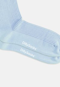 Lysblå sokker med ribbet tekstur og mærkenavnet "DillySocks" trykt i hvidt på undersiden.