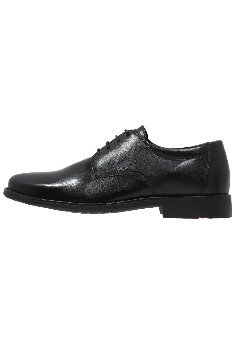 Black leather dress shoe with smooth texture, round toe, five-eyelet lace-up design, and a low-profile black sole with a red accent.