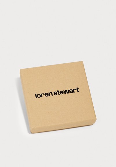 Štvorcová hnedá papierová krabica s hladkým povrchom a matným dokončením. Na vrchu je centrálne potlačený čierny text "loren stewart".