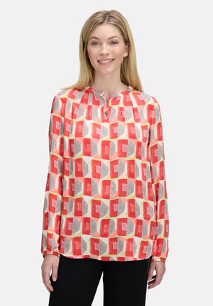 Long-sleeve blouse in lightweight fabric featuring a multi-colored geometric pattern in red, gray, and yellow, with a round neckline and pleats.
