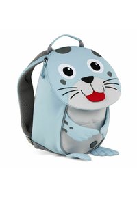 Light blue backpack designed as a seal, featuring a round face with large eyes and a red tongue, gray accents, and a soft texture.