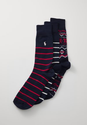 Tre paia di calze navy: uno con strisce rosse, uno a righe grigie e uno con un motivo geometrico in navy, rosso e bianco. Composizione in misto cotone.