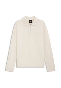 Langärmeliges Poloshirt in Cremefarben mit einem Reißverschluss am Kragen, einer Brusttasche und gerippten Bündchen. Hergestellt aus weichem Stoff, zeichnet es sich durch klare Linien und ein minimalistisches Design aus.