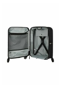 Valise noire avec une fermeture éclair ouverte, dotée d'un intérieur gris à motif à pois, d'une poche en maille, et de sangles croisées pour sécuriser le contenu.