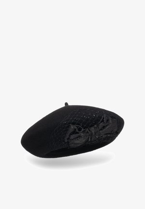 Black wool beret featuring a textured netting overlay and a satin bow accent with sparkling embellishments. Smooth, semi-structured shape.