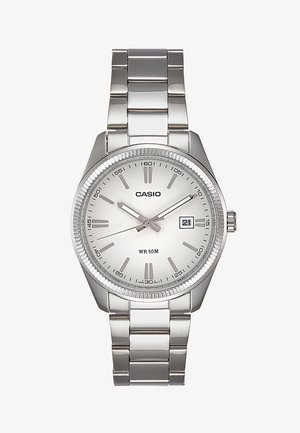 Sidabrinis metalinis rankinis laikrodis su apvaliu ciferblatu, baltu skaičiumi ir analoginiais žymekliais. Odoje yra datos rodymas ir atsparumas vandeniui iki 50 metrų.