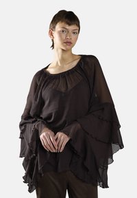 Czarna bluzka z szyfonu z falbaniastymi rękawami typu dzwon i szerokim dekoltem. Tkanina ma lekką, przewiewną teksturę i delikatnie opływa ciało.