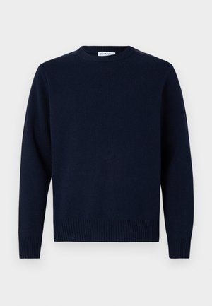 Tamno plava dukserica s okruglim izrezom, rebrastim manžetama i rubom. Napravljena od mekog pletiva, sa jednostavnim, klasičnim dizajnom.