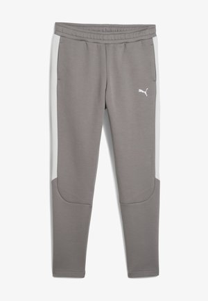 Pantaloni sportivi grigi con pannelli laterali bianchi, cintura elastica e tasche. Realizzati in materiale morbido con design a gamba affusolata. Presentano un accento con logo.