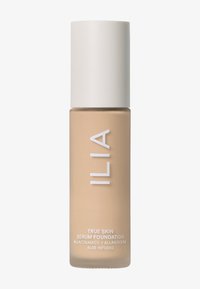 ILIA True Skin Serum Foundation i en frostad beige glasflaska med ett matt vitt lock. Har produktinformation tryckt i vitt.