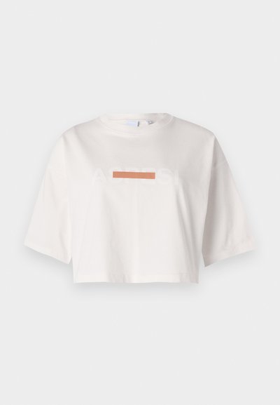 White cropped t-shirt made of cotton featuring short sleeves and a graphic print with the text "ACRESI" and a horizontal orange stripe.