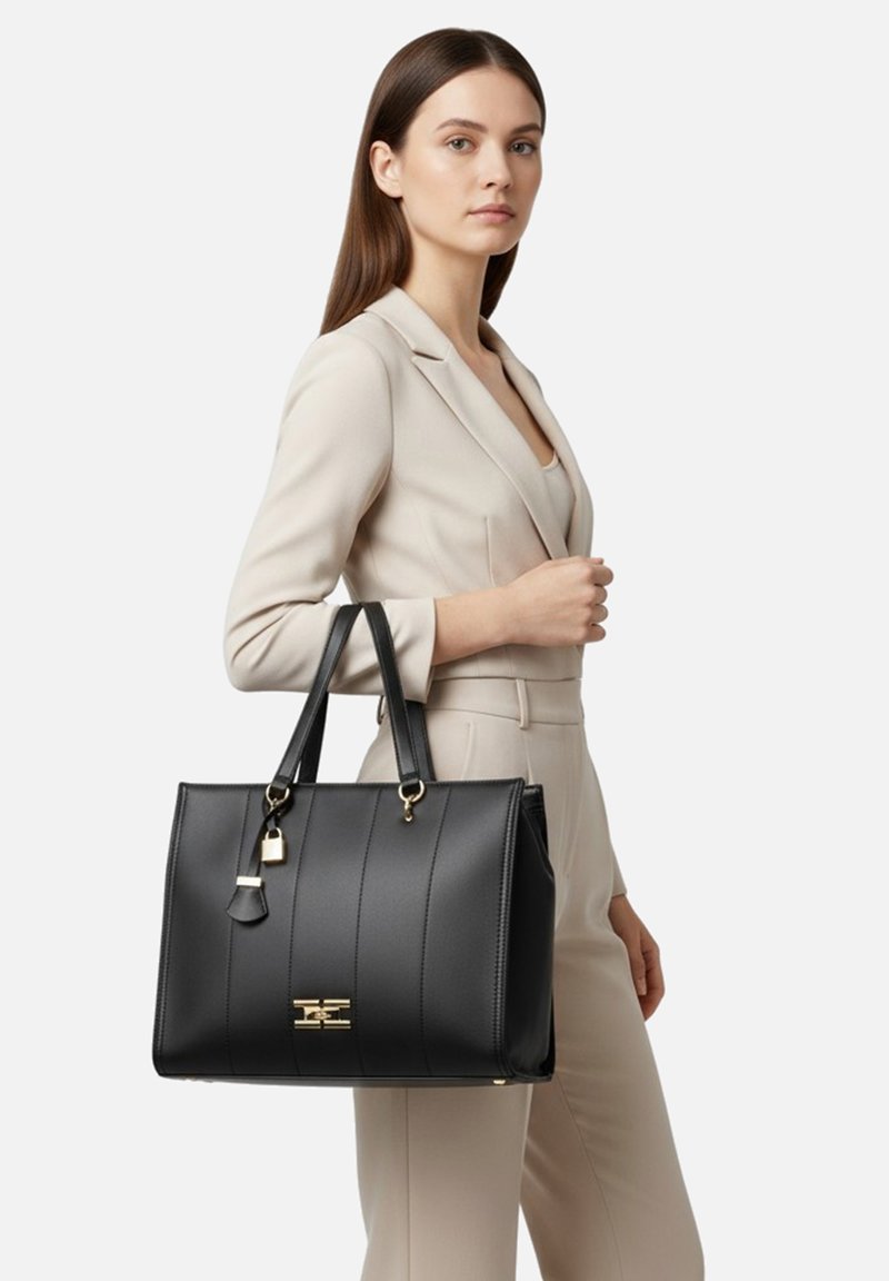 Borsa a mano in pelle nera con cuciture verticali, dettagli hardware dorati, doppi manici e piccolo dettaglio con lucchetto. Design strutturato, interno spazioso.