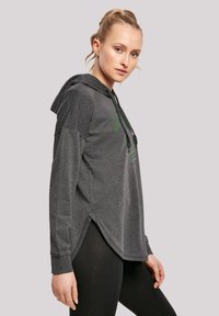 Grå hettegenser med løs passform, med en forb Pocket, sidelommer og et grønt grafisk design. Mykt stoff med en glatt tekstur.