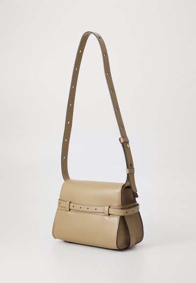 Beige leather handbag with a rectangular shape. Features a wide, adjustable strap with cut-out holes and a belted accent on the front.