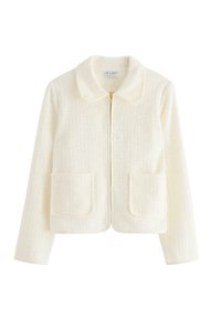 Giacca color crema con colletto tondo, chiusura a zip e due tasche applicate. Realizzata in tessuto strutturato con una finitura morbida.