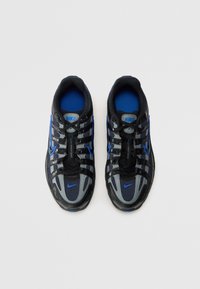 Baskets Nike avec une tige en mesh noir, des accents gris et bleu, un design à lacets et une semelle en caoutchouc avec des détails texturés.