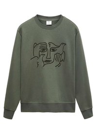 Bluza oliwkowozielona z czarnym rysunkiem linii przedstawiającym twarz otoczoną dwoma rękami i dwoma ptakami na przodzie.