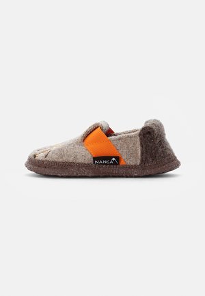 Wool slipper with a light brown upper, orange elastic strap, and dark brown textured sole. Features rounded toe and brand tag.