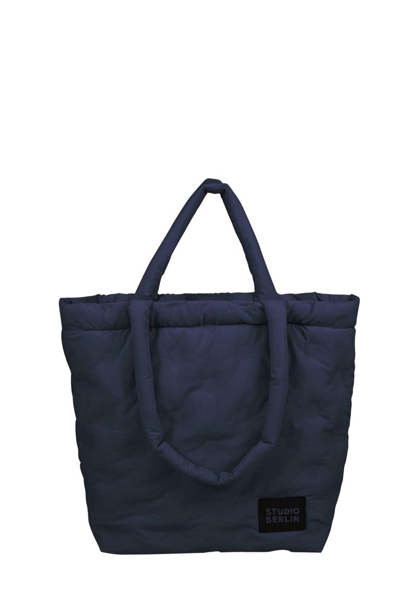 Kara navy zīda soma ar diviem izturīgiem, noapaļotiem rokturiem un taisnstūra formu. Iekļauts neliels melns uzlīme ar tekstu "STUDIO BERLIN".