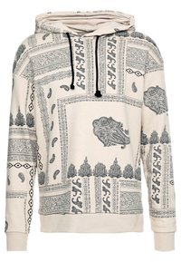 Felpa beige con stampe paisley nere e geometriche, dotata di cappuccio con cordino e polsini e orlo a coste per una vestibilità rilassata.